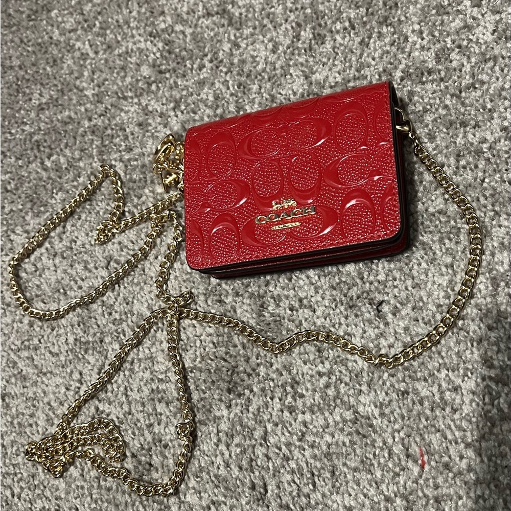 Coach Red Crossbody wallet, dimensions are 4 by 5, will hold a couple items.